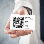 Businessman holding QR code business card with personal data. Modern technology concept.